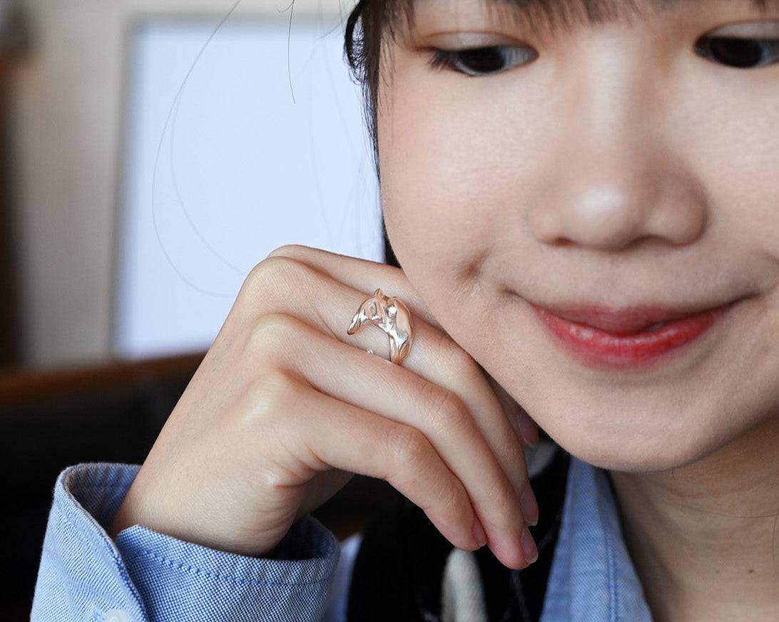 A woman wearing the Sterling Silver Whale Tail Ring and smiling